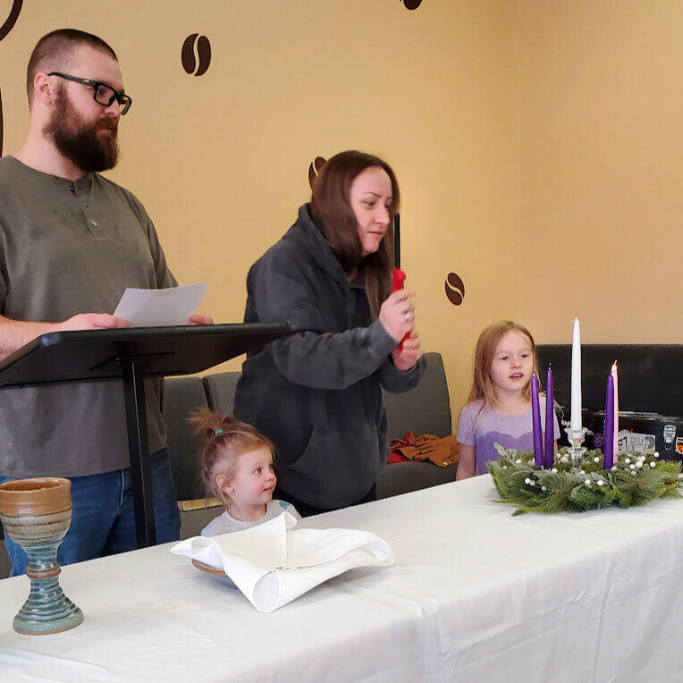 Map young family lighting an advent wreath